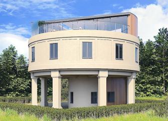 A water tower converted to a holiday home overlooks woods and fields.