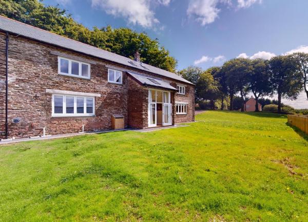 A Devon barn conversion overlooks a securely-fenced spacious lawn.