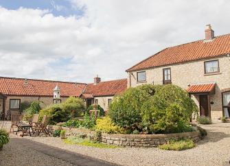 Exterior of a barn conversion overlooking a garden courtyard