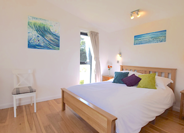 King size bed in bright spacious bedroom