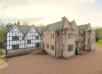 A large country Manor house with a timbered Tudor wing.