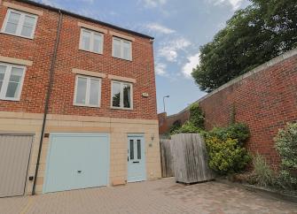 3-storey exterior of a Whitby holiday home with a garage on the ground floor