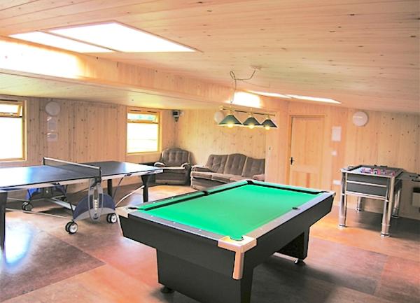 A games room with table football, pool and table tennis tables