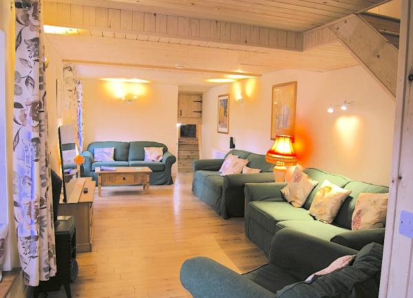Lounge with 3 sofas and a coffee table.