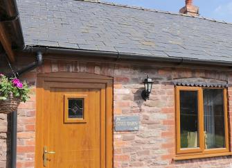 Exterior of a slate-roofed, single-storey barn conversion in Leominster.