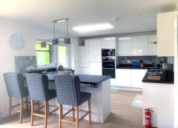 Kitchen with a breakfast bar and high stools.