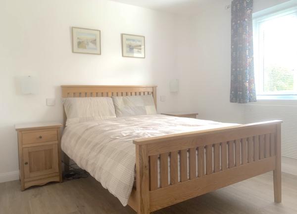 Double-bedroom with pictures on the wall.