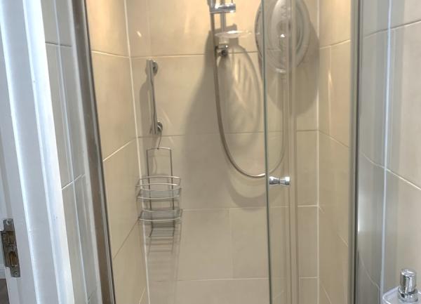 Shower room with a glass door.