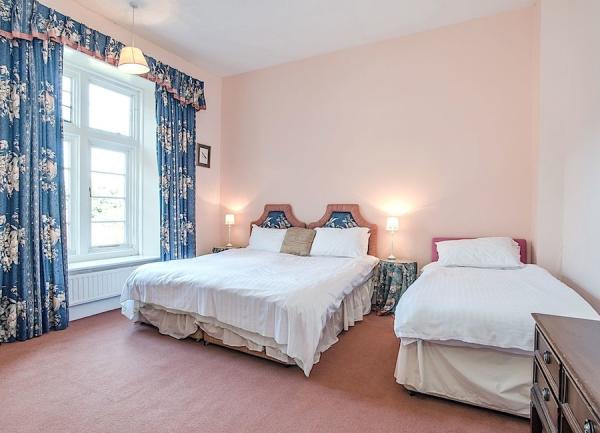 Family bedroom with a double and single bed.
