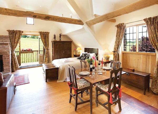 A dining table and 2 chairs in a Malvern Hills cottage kitchen