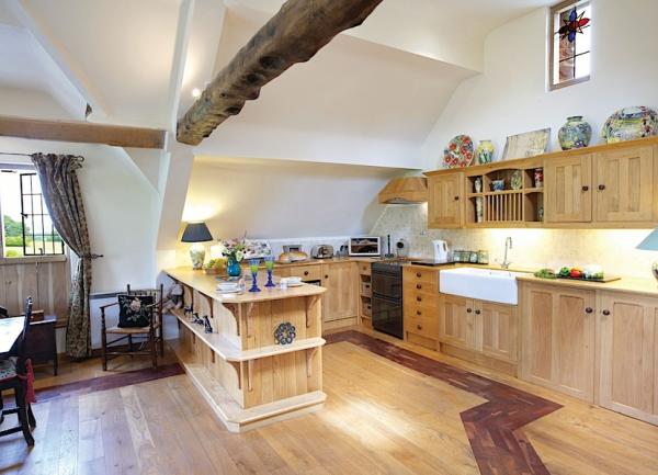 An oak beamed fitted country kitchen with integrated units.