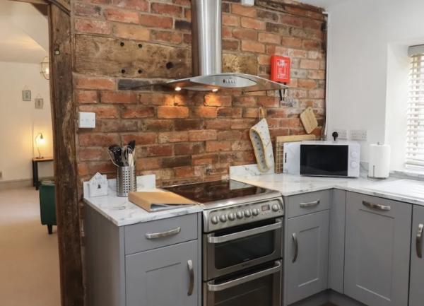 Kiitchen corner show ing fitted units with an integrated range cooker snd