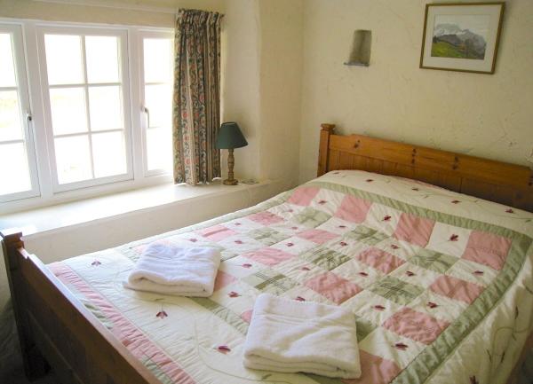 Double Bedroom with a large bed and towel sets.