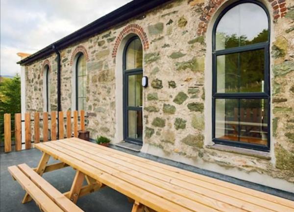 A terrace with a long wooden picnic table for 16.