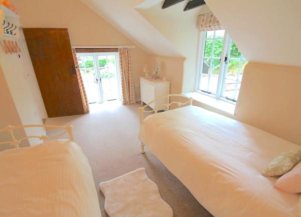 Twin bedroom with beds and chest of drawers.