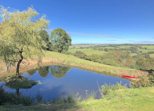 Large pond with Exmoor rural views beyond.