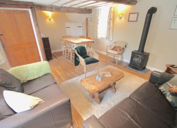 Louunge with woodburner, sofas and coffee table.