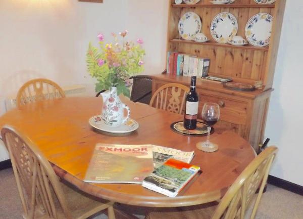 Dining room with wooden table, four chairs and a Welsh dresser