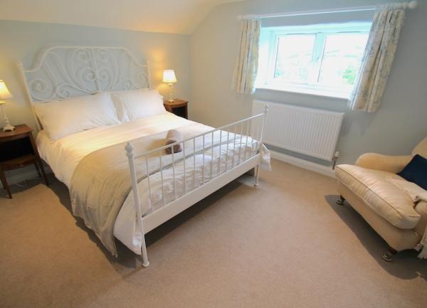 Double bedroom with bed and armchair