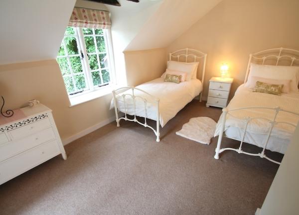 Twin bedroom with beds and dressing table