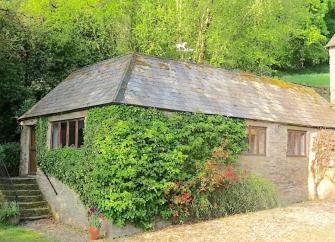 Ivey-clad exterior of an Exmoor stone barn conversion.