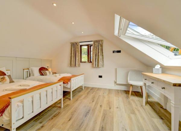 Twin bedroom with dressing table and armchair.
