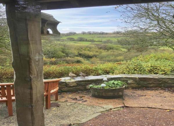 Rural views from a patio with table and chairs.
