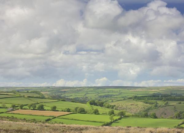Exmoor farmland view of fields under a cloudy sky.