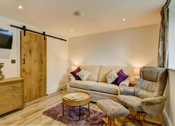 Lounge corner with sofa, armchair and coffee table.
