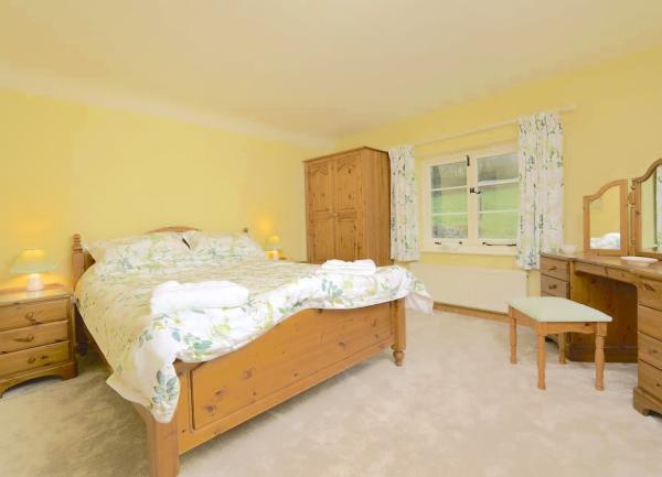 Double bedroom with bed, wardrobe and dressing table.