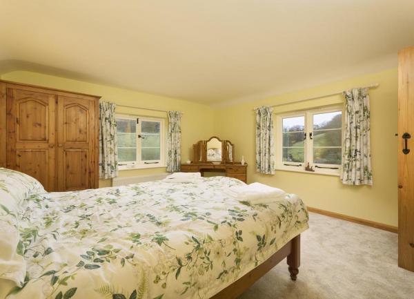 Dual aspect double bedroom with bed and dressing table.