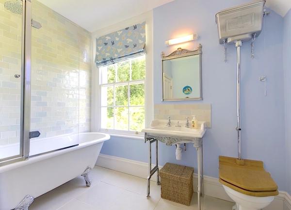 Bathroom with a bath/shower, basin and WC.
