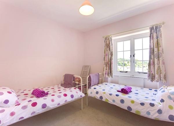 Twin bedroom with two beds and towel sets.