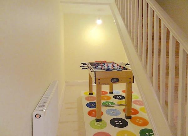 Table football under the stairs.
