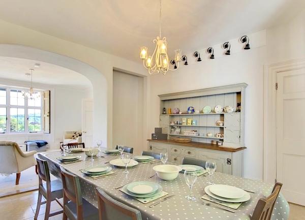 Dining area with table, 8 chairs and dresser.