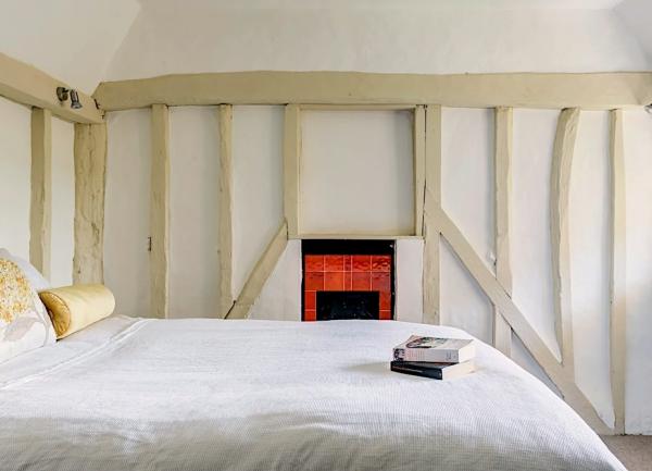 Double bedroom with exposed oak beams in walls.