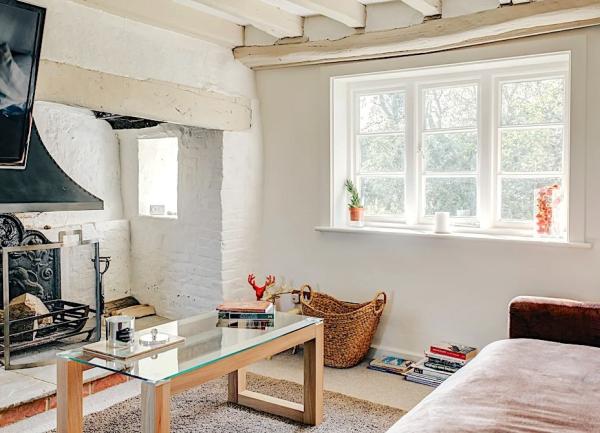 Lounge with open fire, coffee table and sofa.