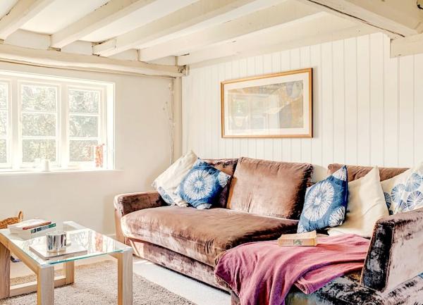 Wood-panelled lounge with large sofa and coffee table.
