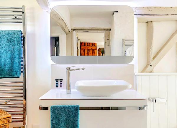 Ensuite bathroom with stylish basin and heated towel rail.