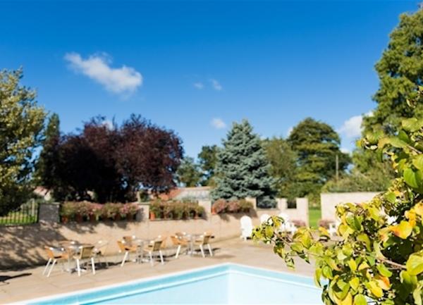 Secure open air pool with stone wall.