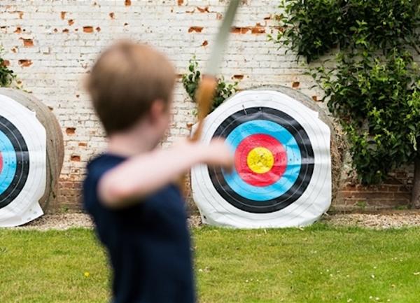 Young archer aims at a target.