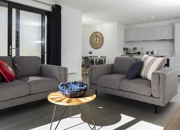 Lounge and kitchen spaces in an open-plan living area.