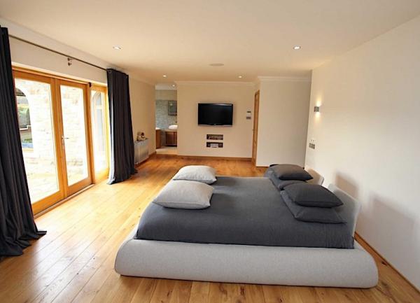 Double bedroom with bed, full-height-windows-tv