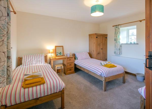 Twin bedroom with bed, dressing table and wardrobe.