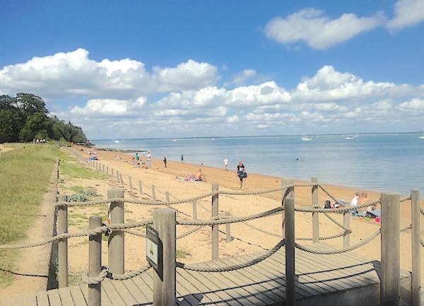 People play on a ocal sandy beach.