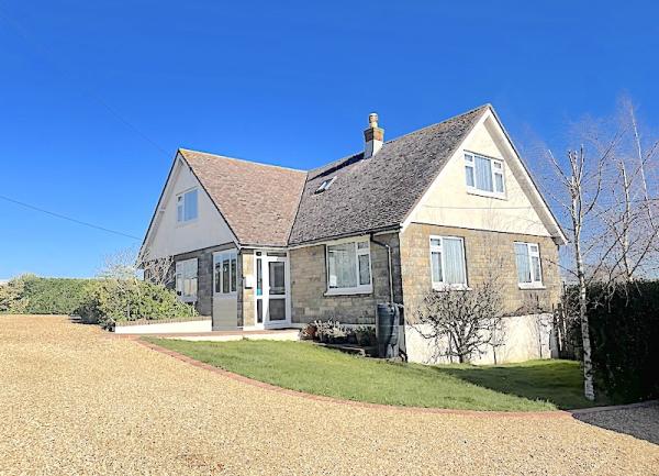 Exterior of a large modern house and garden.