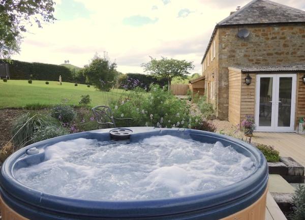 Hot tub on a deck with rural views.