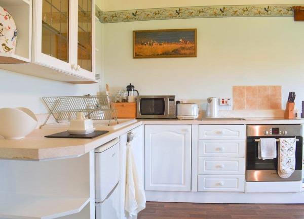 Fitted kitchen with oven, fridge, microwave