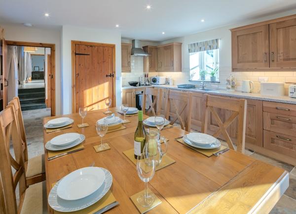 Kitchen diner with pine table and fitted units.