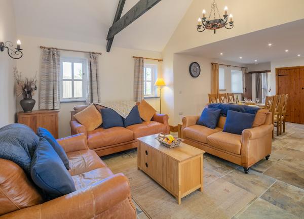 Lounge with 3 leather sofas and coffee table.